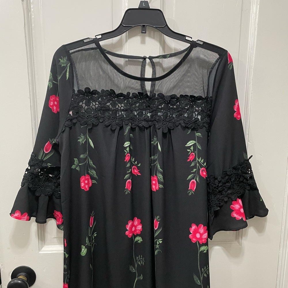 Floral black top with mesh and lace details.